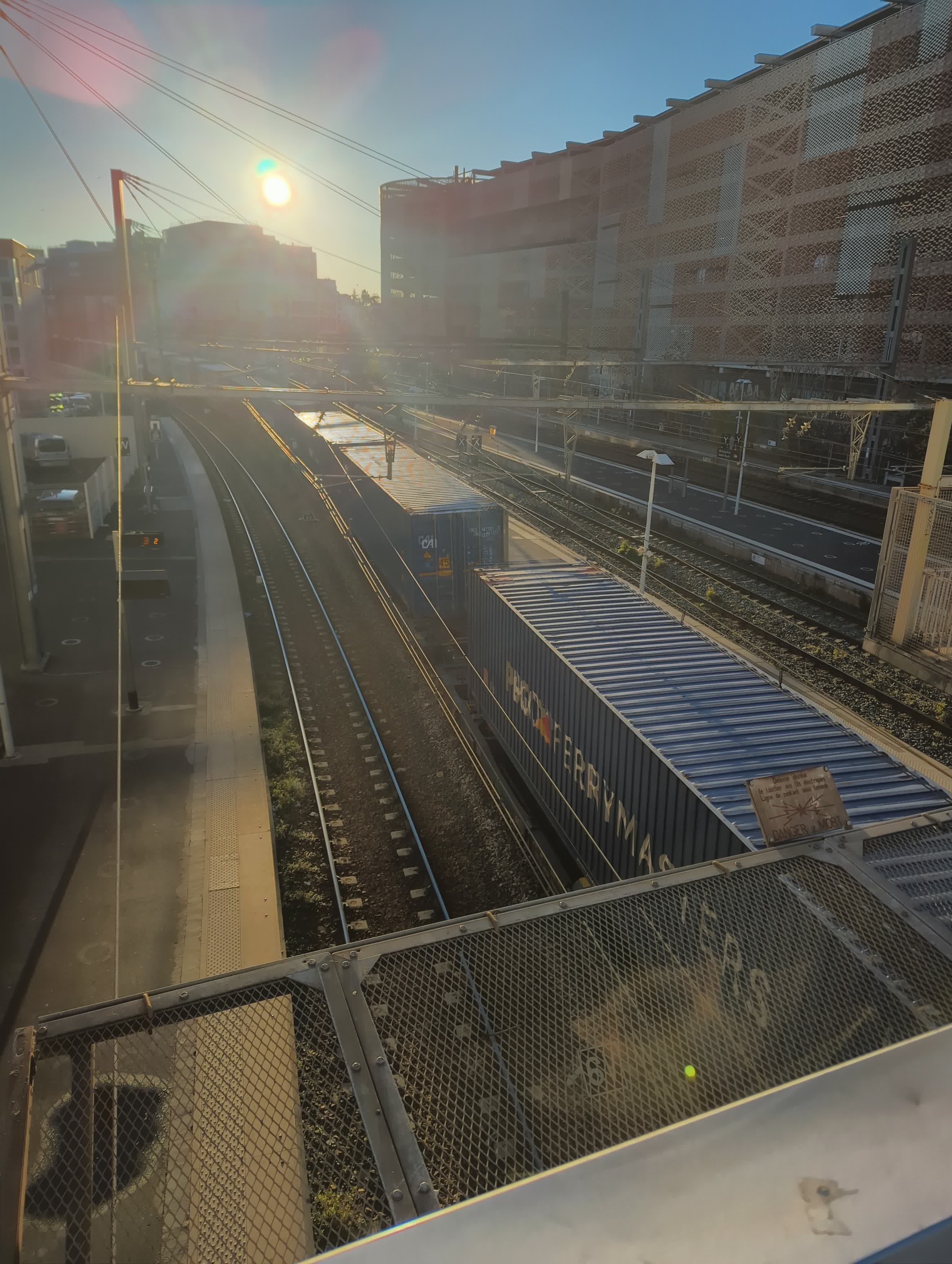 A photo taken from the top floor of the station, showing the tracks and a freight train